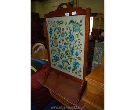 A tapestry fire screen.