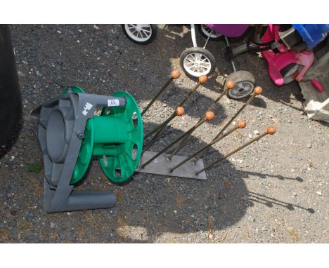 A Hose pipe reel (no hose) and Wellington boot stand.