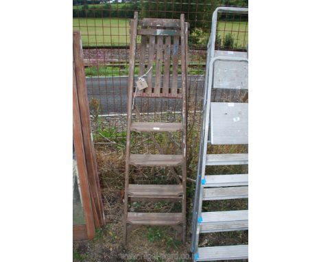 A wooden 5 rung step ladder.