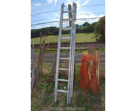 A three section extension aluminium ladder.
