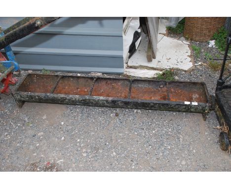 A pig trough, 5' long x 12" wide.
