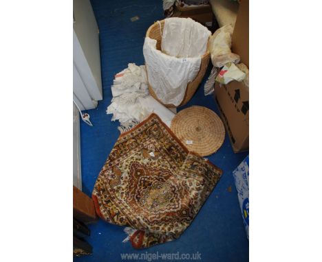 A round linen basket with lace and crochet and a small carpet.