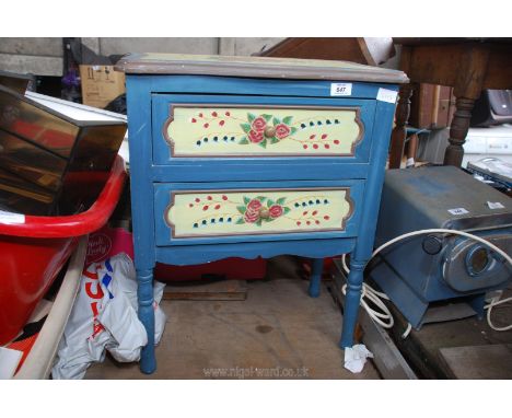 A painted blue with flowers cupboard having two drawers, 20" x 2' x 11" deep.