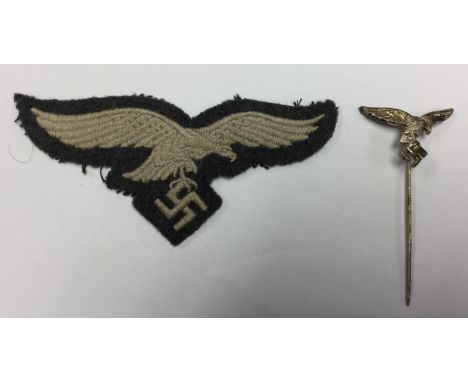 WW2 Third Reich Luftwaffe breast eagle, unissued condition. Along with a Luftwaffe droop tail eagle stick pin, maker marked "