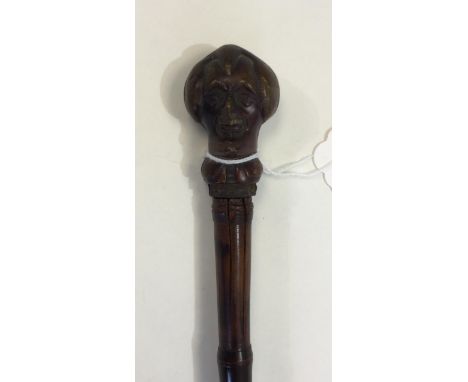 A Bamboo Sword Stick Walking Cane with novelty "Mr Punch" head to handle. Dark brown patinated finish. 36cm long quatrefoil b