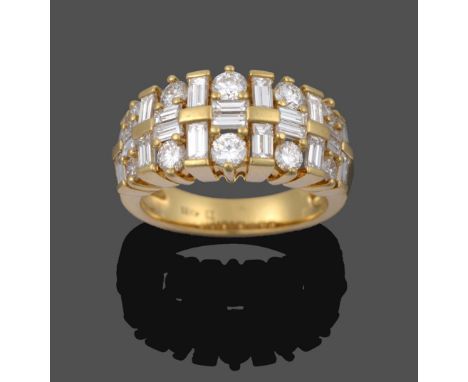 A Diamond Ring, pairs of graduated baguette cut diamonds running parallel to the shank spaced by yellow bars, sits between tw
