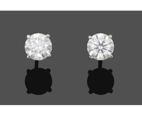 A Pair of 18 Carat White Gold Diamond Solitaire Earrings, the round brilliant cut diamonds in four claw settings, total estim