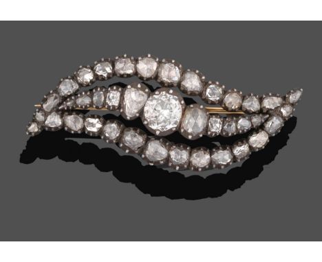 A Georgian Diamond Brooch, the asymmetric form of a central row of graduated old cut and rose cut diamonds within a border of
