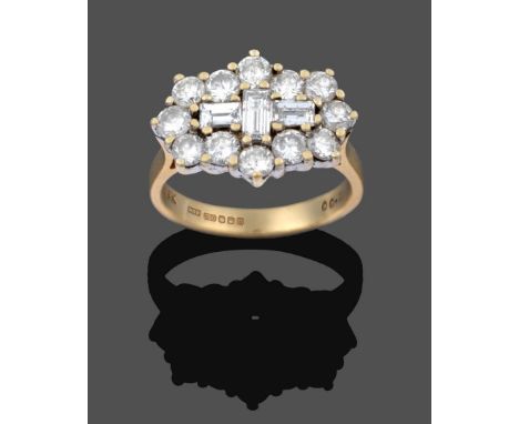 An 18 Carat Gold Diamond Cluster Ring, three baguette cut diamonds set centrally within a border of twelve round brilliant cu