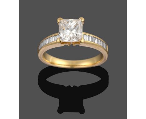 A Diamond Solitaire Ring, the princess cut diamond in a yellow four claw setting, to baguette cut diamond channel set shoulde
