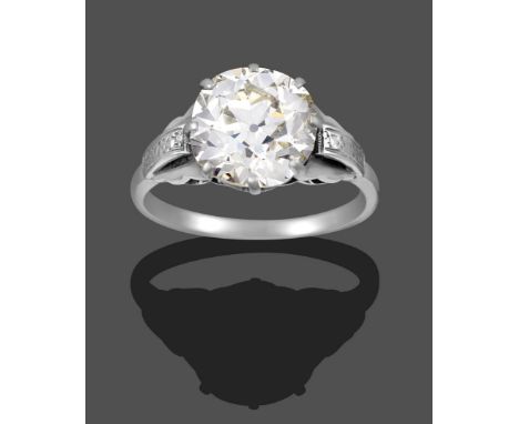 A Diamond Solitaire Ring, the old cut diamond in a white claw setting, to fancy panelled shoulders on a plain polished shank,