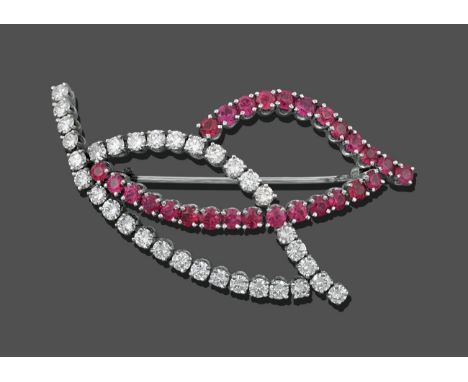 A Ruby and Diamond Brooch, in the form of two leaves, one outline set throughout with round brilliant cut diamonds, the other