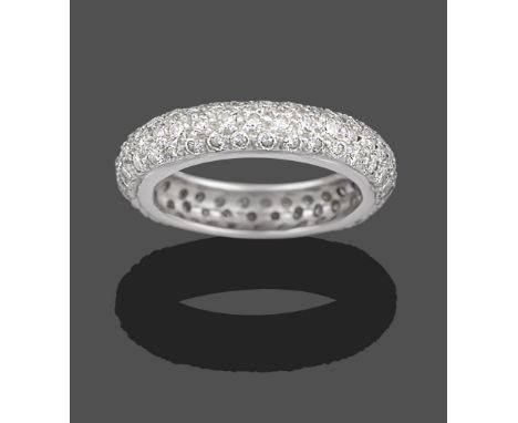 A Diamond Bombé Eternity Ring, three rows of round brilliant cut diamonds in white claw settings, total estimated diamond wei