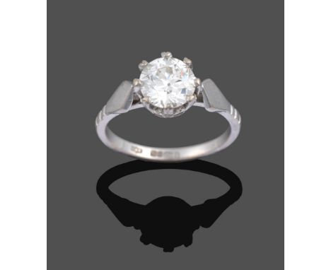 An 18 Carat White Gold Diamond Solitaire Ring, the round brilliant cut diamond in a claw setting, to pointed lined shoulders 