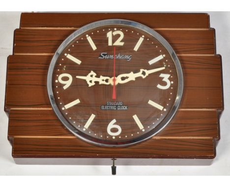 Sunchang standard electric clock, a mid-20th Century stained and simulated wood electric wall clock.