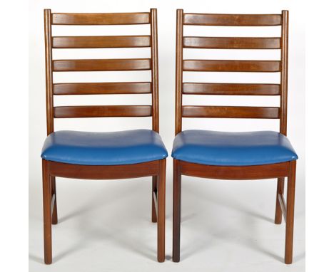Two mid 20th Century teak ladder back dining chairs, with leather seats.