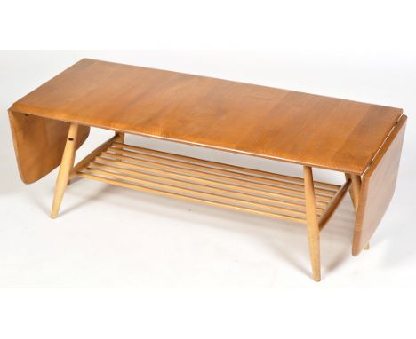 Ercol: a light elm and beech wood drop-leaf coffee table, with magazine rack below on splayed turned legs, 159 extended x 46 