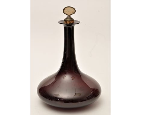 A purple glass decanter, of squat baluster form with elongated neck and cork stopper, 23cms (9in.) high.