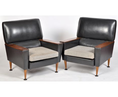A pair of vintage mid 20th Century armchairs, with teak arm rests, black leather padded back and upholstered cushion, tapered