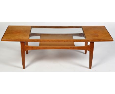 G-Plan: a teak coffee table, rectangular with inset plate glass top and magazine shelf below, 135 x 50 x 43cms high.