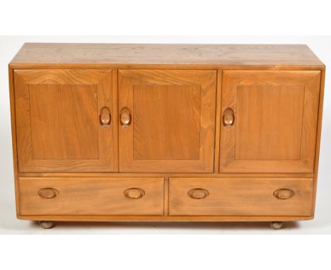 Ercol: a light elm sideboard, rectangular top above a two-door large cupboard with adjustable shelf, a smaller cupboard with 