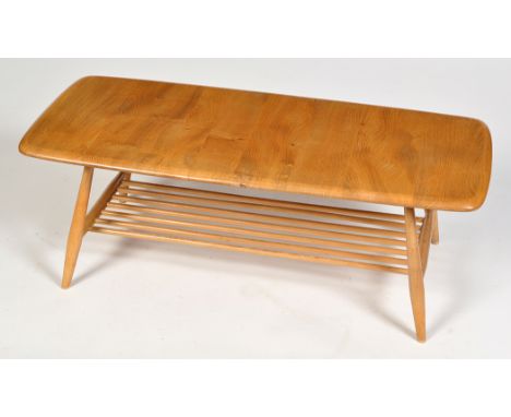 Ercol: a light elm and beech wood occasional coffee table, rectangular top, on splayed turned legs with magazine rack below, 