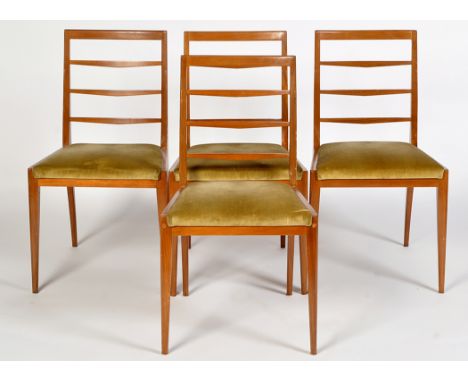 Four mid 20th Century teak ladder back dining chairs with padded seats.