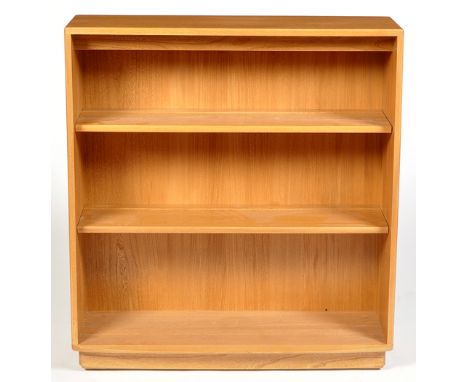 Ercol: a light elm open bookcase, with bowed lower tier, on plinth base, 91.5 x 99cms high.