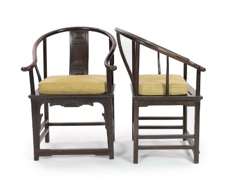 A pair of Chinese tielimu horseshoe-back armchairs, 18th/19th century,each central panelled back support above a panelled sea