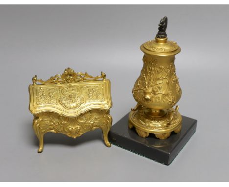A novelty gilt metal, serpentine shaped miniature chest inkwell and a similar urn shaped inkwell,Chest 11 cms wide.