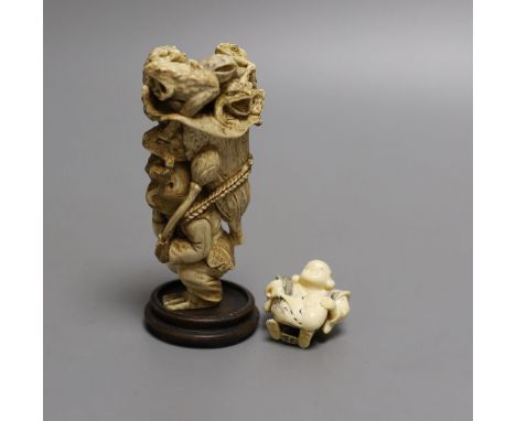 A Japanese ivory okimono of a monkey carrying a lotus leaf containing toads, on its back and an Ivory Netsuke of a mask maker