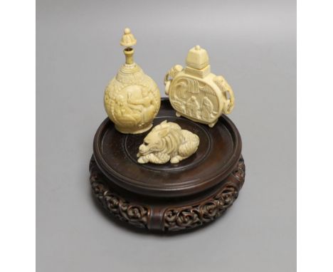 A 19th-century European carved ivory snuff bottle, and an early 20th century Chinese ivory snuff bottle and an ivory Netsuke 