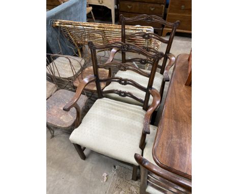 A set of six Chippendale style mahogany dining chairs with pierced ladder backs, two with arms