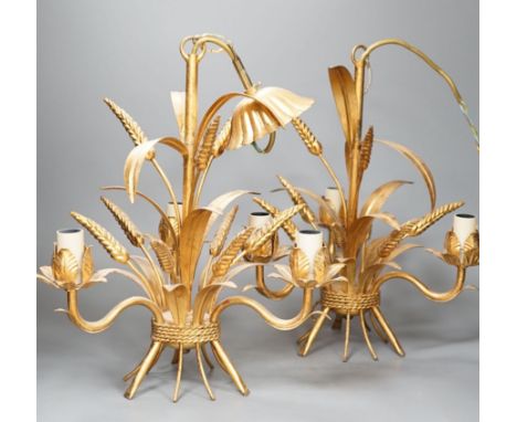 A pair of gilt metal wheat sheaf three light chandeliers