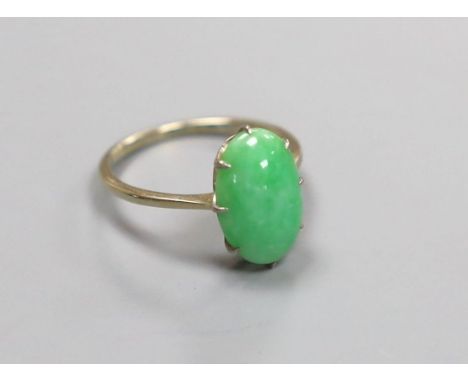 A white metal and oval cabochon jade set ring, size L, gross 2.4 grams.