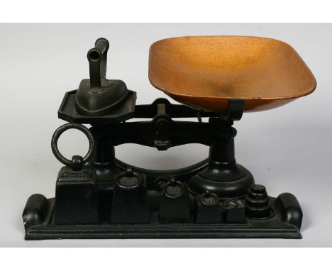 A vintage cast iron set of weighing scales with matching graduated weights stamped Crane.