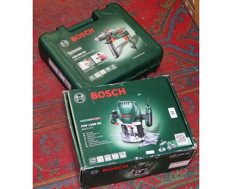 A cased 230 volt Bosch 680 watt hammer drill model No. PSB680RE along with a boxed plunge router model No. POF1200AE.