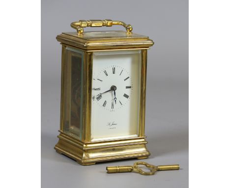 A gorge cased lacquered brass carriage clock with enamel dial signed St James.