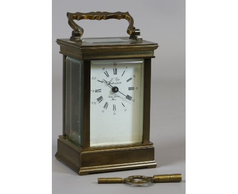 A French brass cased carriage clock with enamel dial signed L'Epee having Roman and Arabic numeral markers.