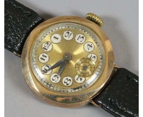 A ladies 9ct gold cased Swiss wristwatch with engine turned dial with enamel Arabic numeral markers and subsidiary seconds, a