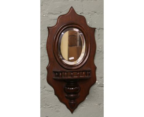 A mahogany scallop edge and mirror back wall bracket.