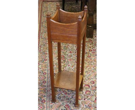 A carved oak planter raised on square supports.