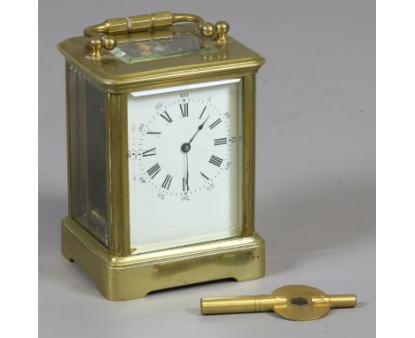 A miniature brass cased carriage clock with enamel dial having Roman and Arabic numeral markers.