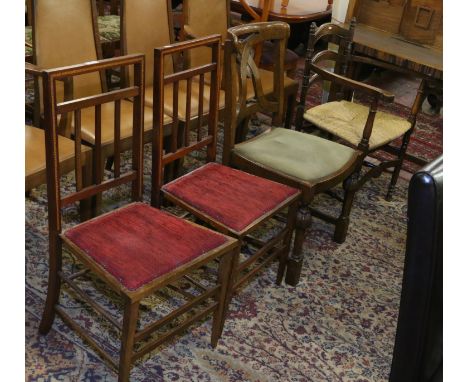 A pair of Edwardian inlaid mahogany stick back bedroom chairs,a carved oak side chair and a ladder back rush seat armchair.