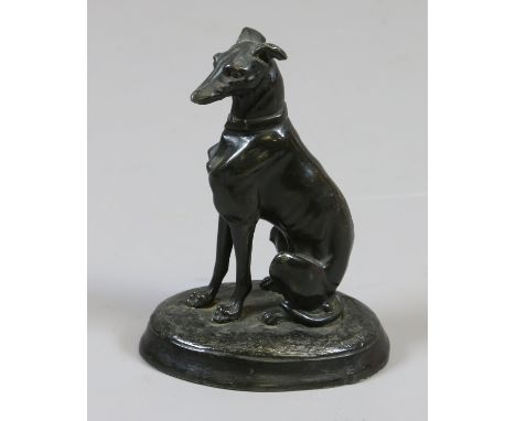 Style of Pierne Jules Mene, a patinated bronze model of a greyhound seated on an oval plinth.