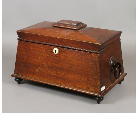 A C19th mahogay sarcophagus tea caddy with faux ivory escutcheon raised on turned feet.