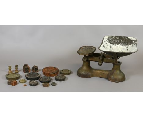 A vintage metal set of weighing scales with weights.