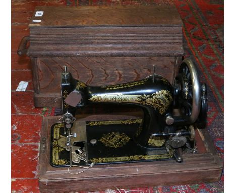 A cased Singer manual sewing machine.