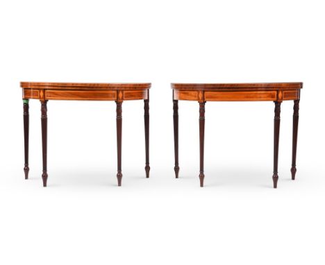 Y A PAIR OF GEORGE III MAHOGANY AND SATINWOOD CROSSBANDED DEMI-LUNE CARD TABLESCIRCA 1800The hinged tops enclosing baize line