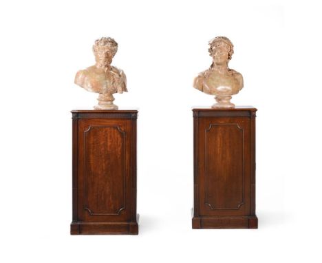 A PAIR OF GEORGE III MAHOGANY PEDESTAL CUPBOARDSIN THE MANNER OF INCE & MAYHEW, CIRCA 1790The left hand cupboard opening to a